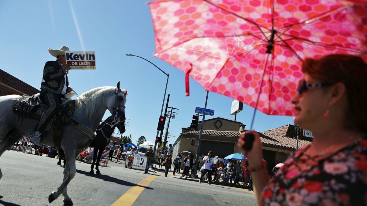 A rider carries a sign for U.S. Senate candidate Kevin de León during the East L.A. Mexican Independence Day parade in September.