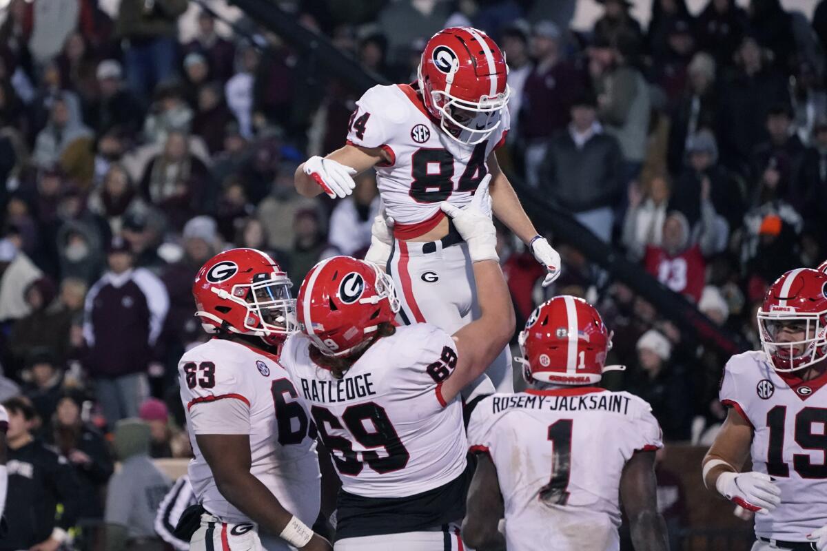 Georgia wide receiver Ladd McConkey (84) gets a lift from offensive lineman Tate Ratledge (69) after scoring a touchdown during the second half of an NCAA college football game against Mississippi State in Starkville, Miss., Saturday, Nov. 12, 2022. (AP Photo/Rogelio V. Solis)