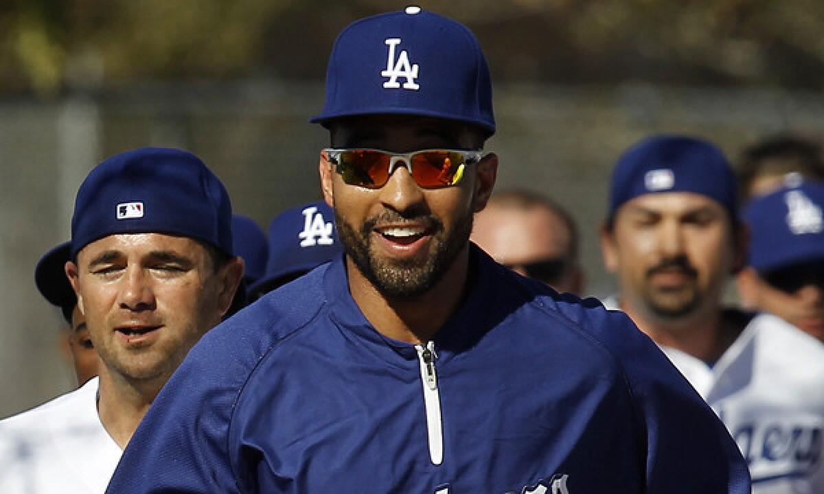 Dodgers outfielder Matt Kemp runs with his teammates at team's spring training facility in Phoenix in February 2013. Will Kemp be healthy enough to play when the season opens?