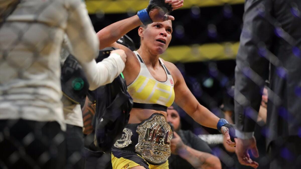 Amanda Nunes celebrates after defeating Miesha Tate by submission to claim the women's bantamweight title belt at UFC 200 on July 9.