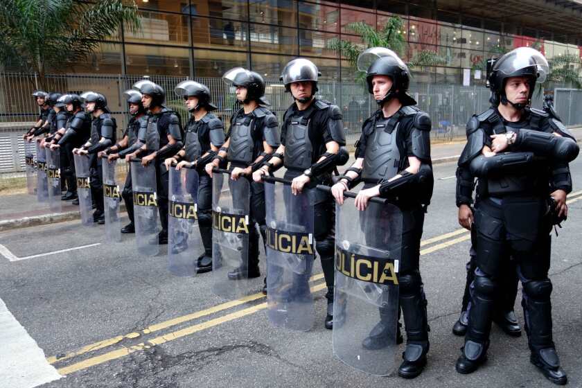 Police stand guard in Sao Paulo, Brazil, on Friday. Police were brought in to remove students who were occupying schools and the state legislature to protest a scandal over funding for student meals.
