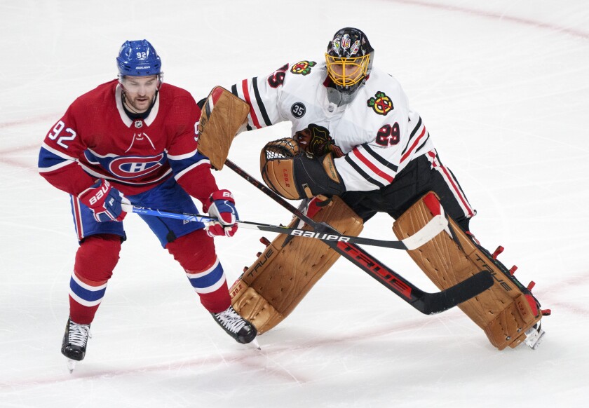 Chicago Blackhawks goaltender Marc-Andre Fleury fends off Montreal Canadiens' Jonathan Drouin after clearing the puck during second period NHL hockey action in Montreal on Thursday, December 9, 2021. THE CANADIAN PRESS/Paul Chiasson/The Canadian Press via AP)-period NHL hockey game action in Montreal, Thursday, Dec. 9, 2021. (Paul Chiasson/The Canadian Press via AP)