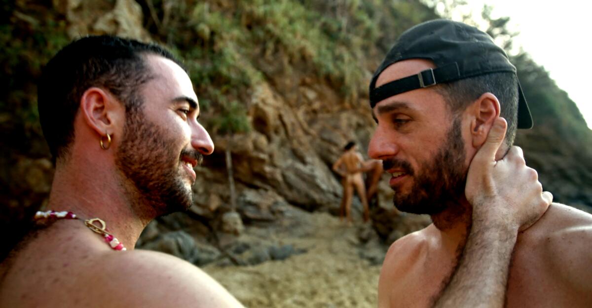 Two men hang out on a clothing-optional Mexican beach.
