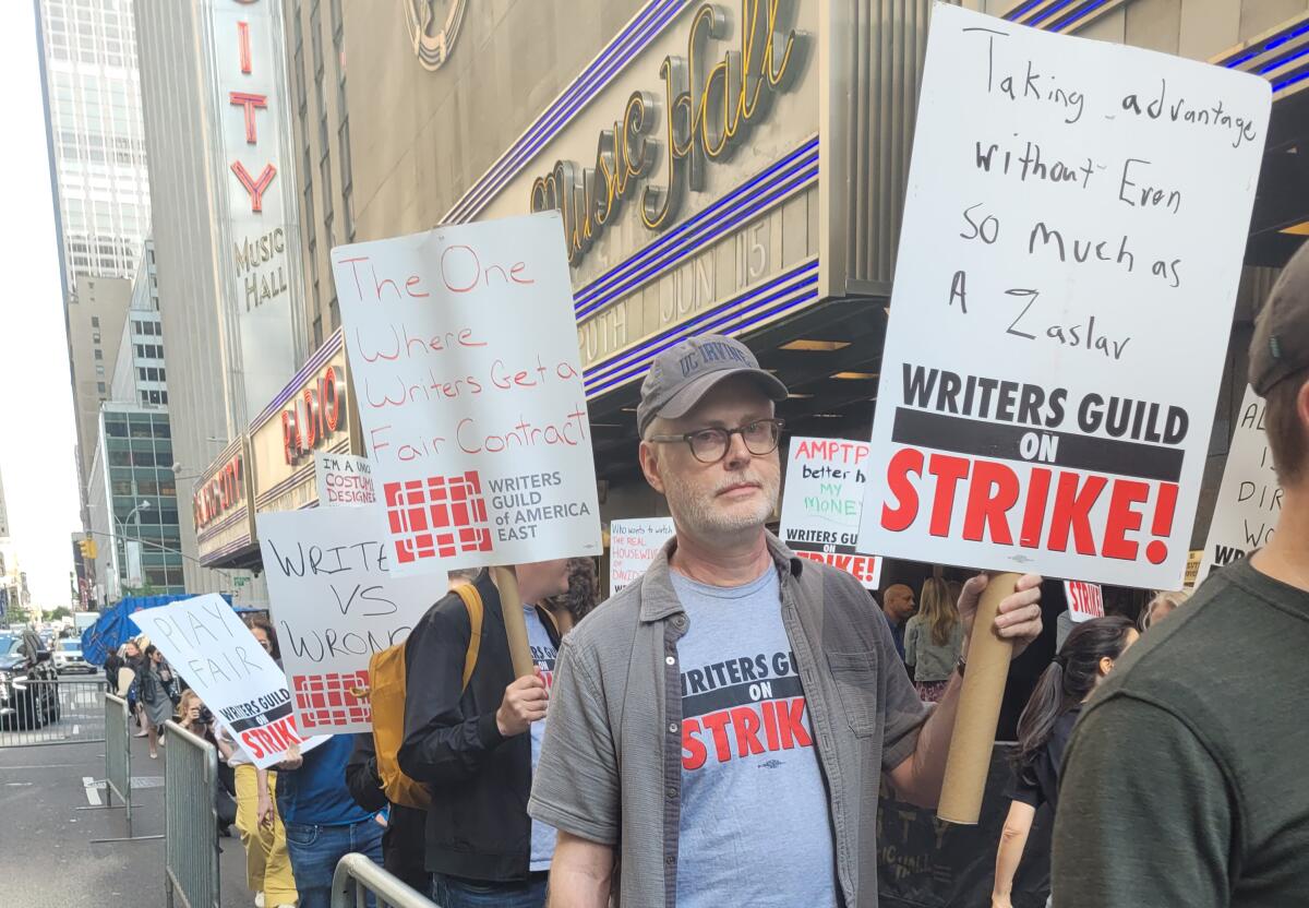 WGA members picket at Radio City Music Hall in New York during NBCUniversal's upfront presentation.