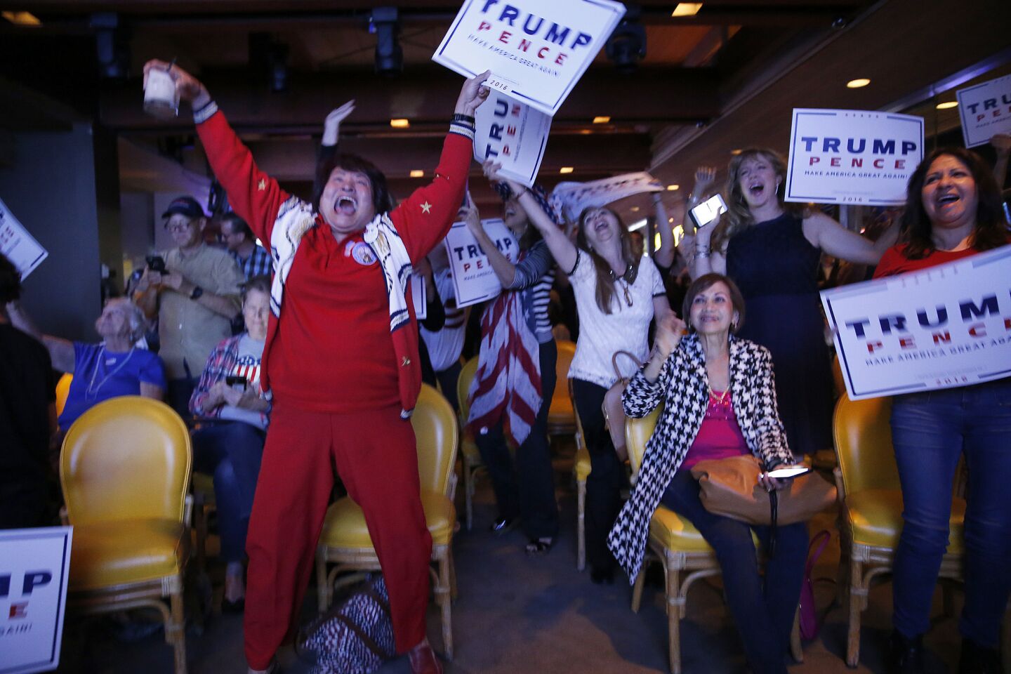 Nellie Gillogly, left, of Santa Ana, joins republicans erupting in celebration at the OCGOP election party at China Palace in Newport Beach.