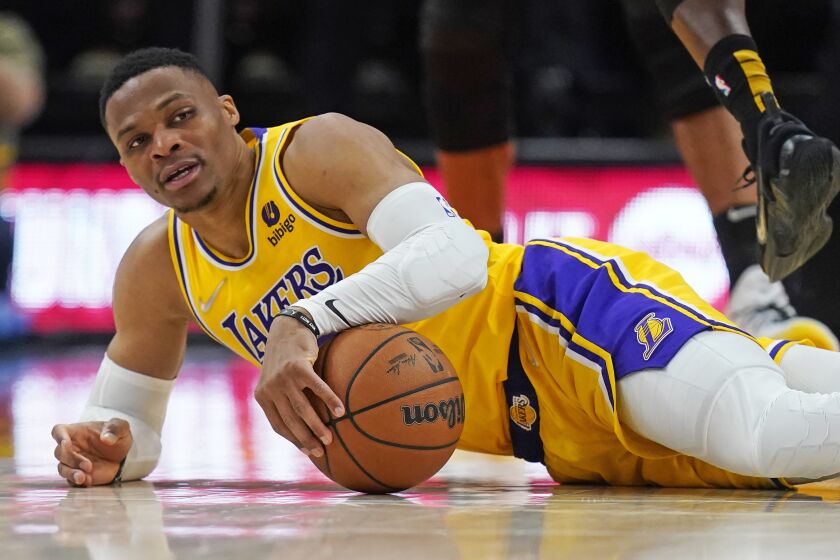 Los Angeles Lakers guard Russell Westbrook falls to the court during the second half of the team's NBA basketball game against the Utah Jazz on Thursday, March 31, 2022, in Salt Lake City. (AP Photo/Rick Bowmer)
