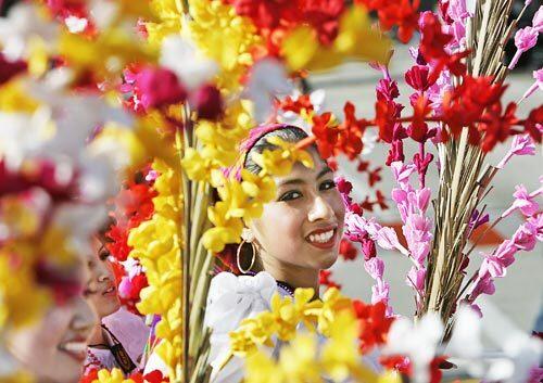 A young beauty marches with the Banda de Musica Instituto Nacional de El Salvador along Colorado Blvd.