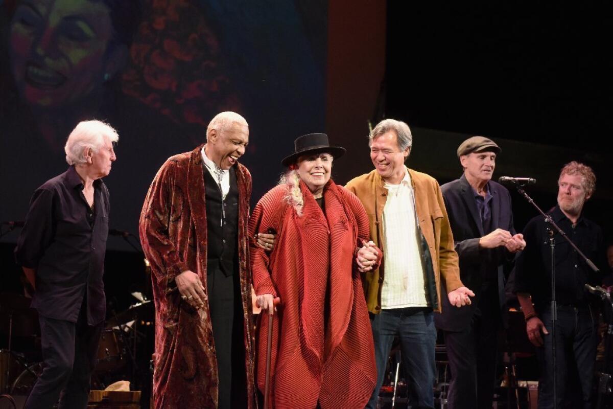 Joni Mitchell, flanked by Graham Nash (far left) and James Taylor (second from right), was the guest of honor Wednesday.