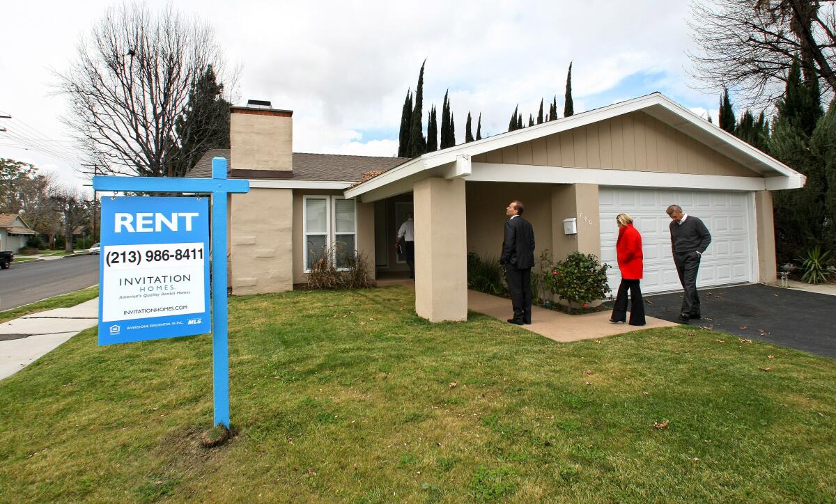 CANOGA PARK, CA-FEBRUARY 8, 2013: Officials from Invitation Homes, tour a home on Casaba Ave. in Canoga Park that the company recently bought, fixed up and turned into a rental property. Invitation Homes is a subsidiary of the hedge fund Blackstone. (Mel Melcon/Los Angeles Times). Original caption: Left to right-Mark Beisswanger, (now former) Chief Operating Officer of Invitation Homes, Cassandra Bujarski, principal, Sard Verbinnen & Co, and Eric Elder, Vice President of Marketing and Communications, Invitation Homes, tour a home on Casaba Ave. in Canoga Park that the company recently bought, fixed up and turned into a rental property. Invitation Homes is a subsidiary of the hedge fund Blackstone. (Mel Melcon/Los Angeles Times)
