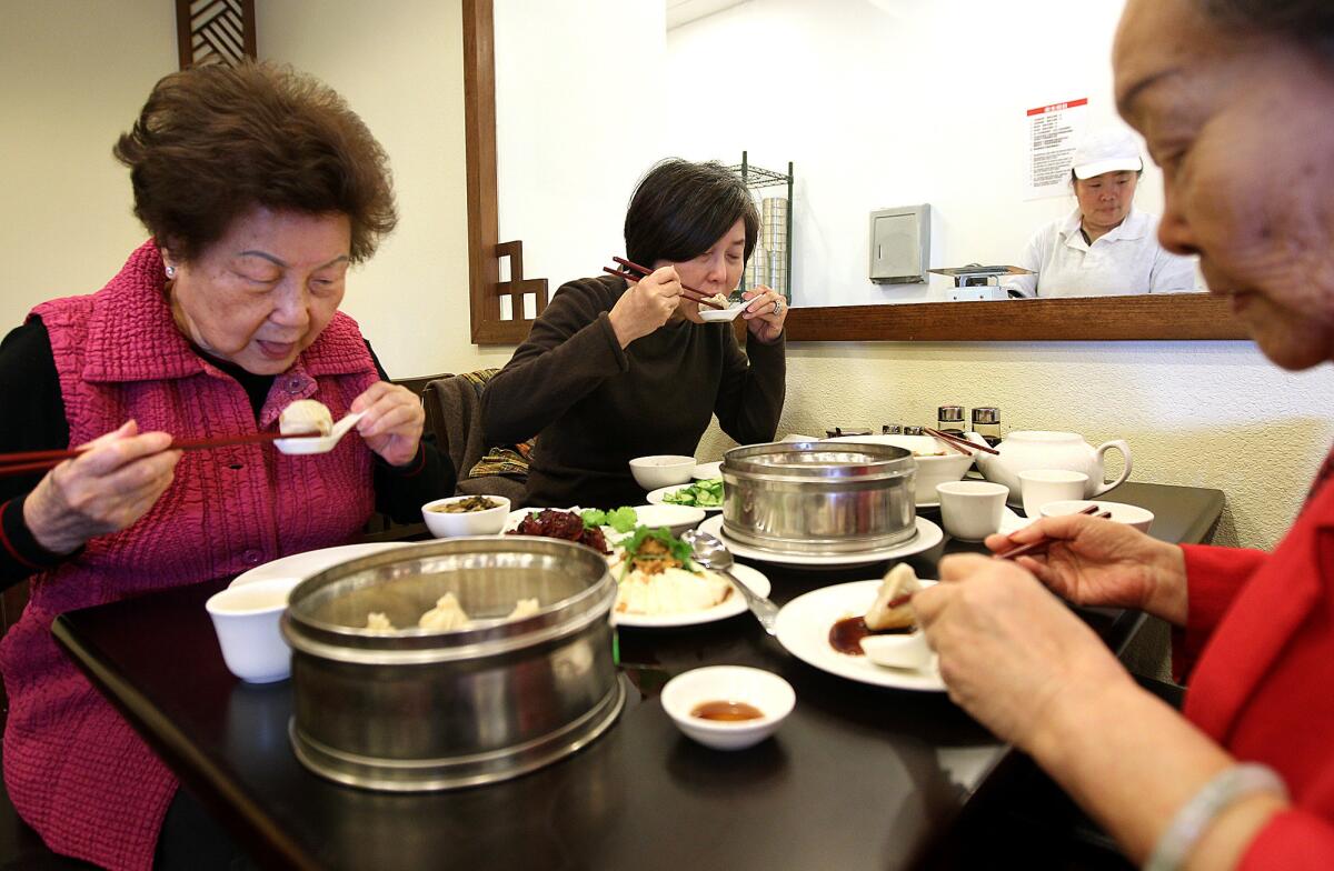 Coco Chang, left, of Whittier, her daughter Fanny Yuan, of Walnut, center, and friend Ann Wu, of Monterey Park share lunch at Wang Xing Ji in San Gabriel.