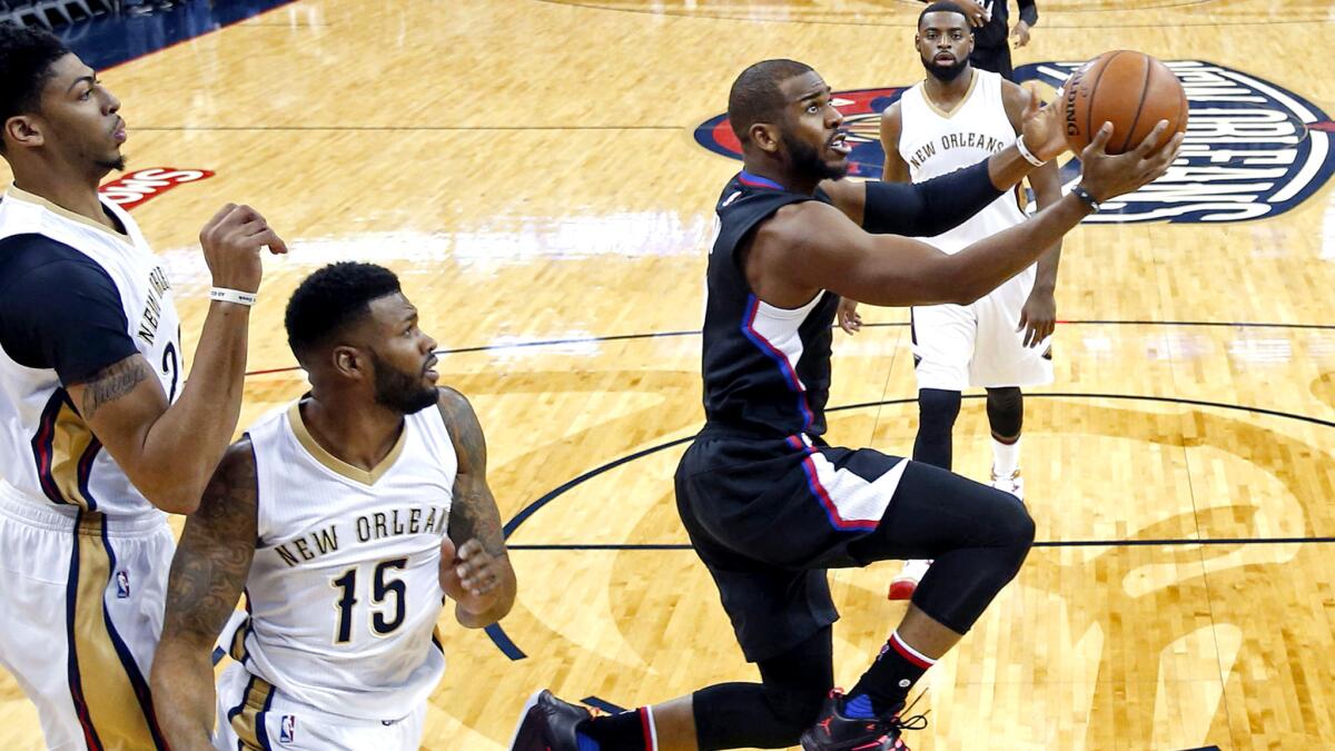 Clippers point guard Chris Paul gets past the Pelicans defense for a reverse layup during the first half Thursday.