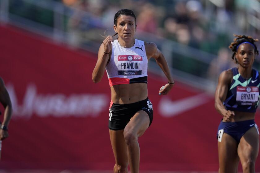 Jenna Prandini wins a semi-final in the women's 200-meter run.
