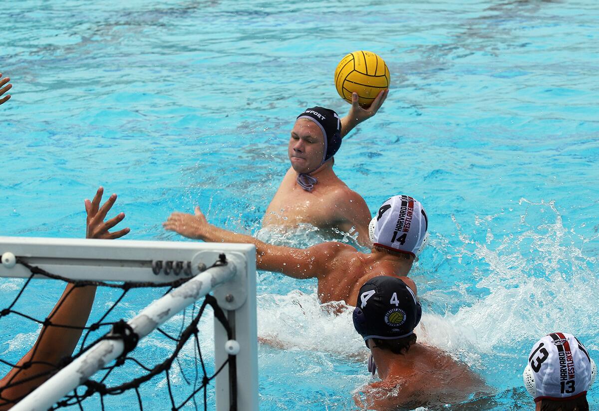 Newport Harbor's Finn LeSieur (7) scores for the Sailors' water polo team during a match against Harvard-Westlake.