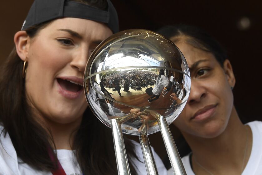 Chicago Sky center Stefanie Dolson, left, and forward/center Candace Parker, celebrate their 2021 WNBA Championship during a rally at Millennium Park on Tuesday, Oct. 19, 2021, in Chicago. (AP Photo/Matt Marton)