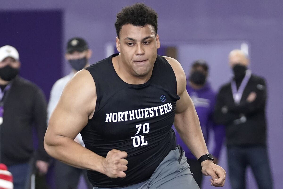 FILE - Northwestern offensive lineman Rashawn Slater participates in the school's Pro Day football workout.