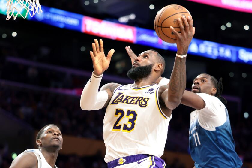 Los Angeles, California March 10, 2024-Lakers LeBron James beats Timberwolves Naz Reid.