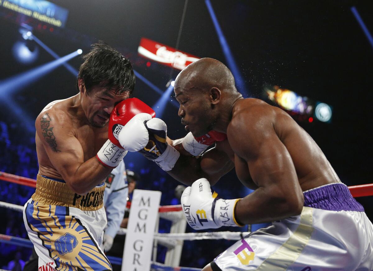 Manny Pacquiao lands a left as he trades punches with Timothy Bradley Jr. during their title fight in Las Vegas.