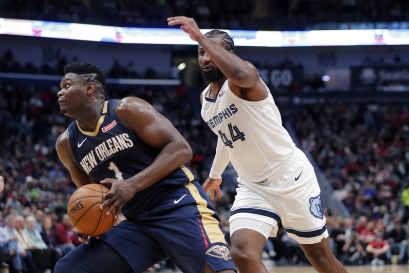 New Orleans Pelicans forward Zion Williamson (1) make a move to the basket next to Memphis Grizzlies forward Solomon Hill (44) during the first half of an NBA basketball game in New Orleans, Friday, Jan. 31, 2020. (AP Photo/Gerald Herbert)
