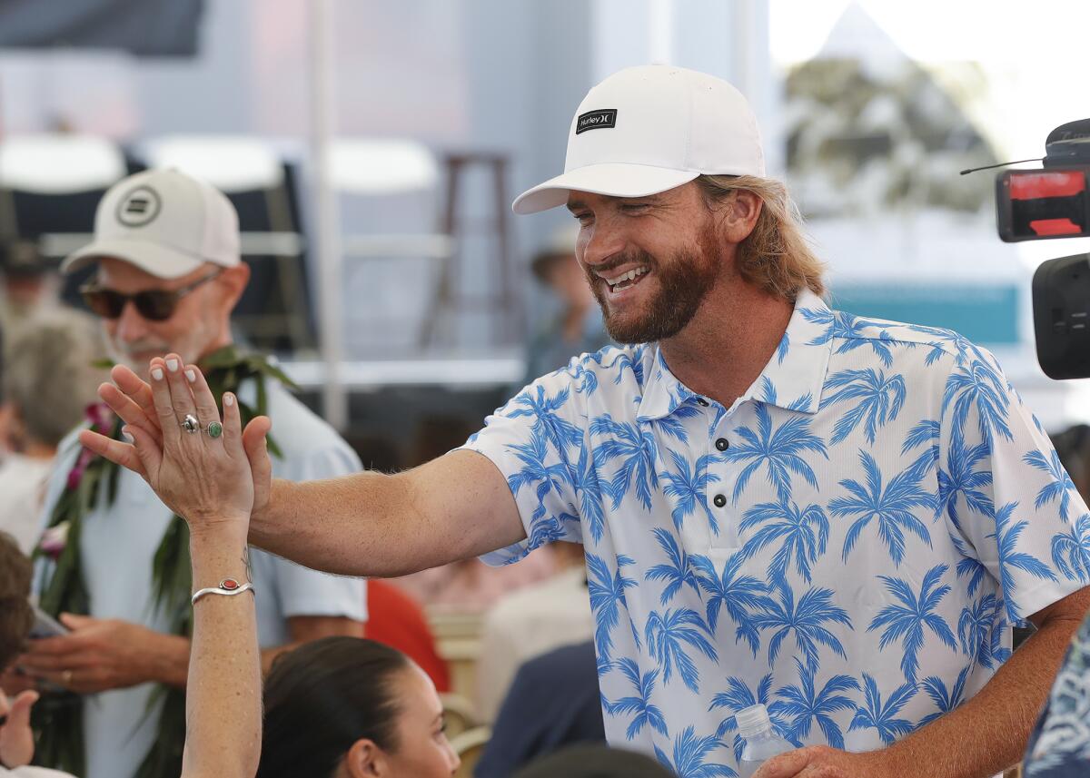 Brett Simpson greets family and friends as he is introduced during 2022 Surfing Walk of Fame induction ceremony Thursday. 