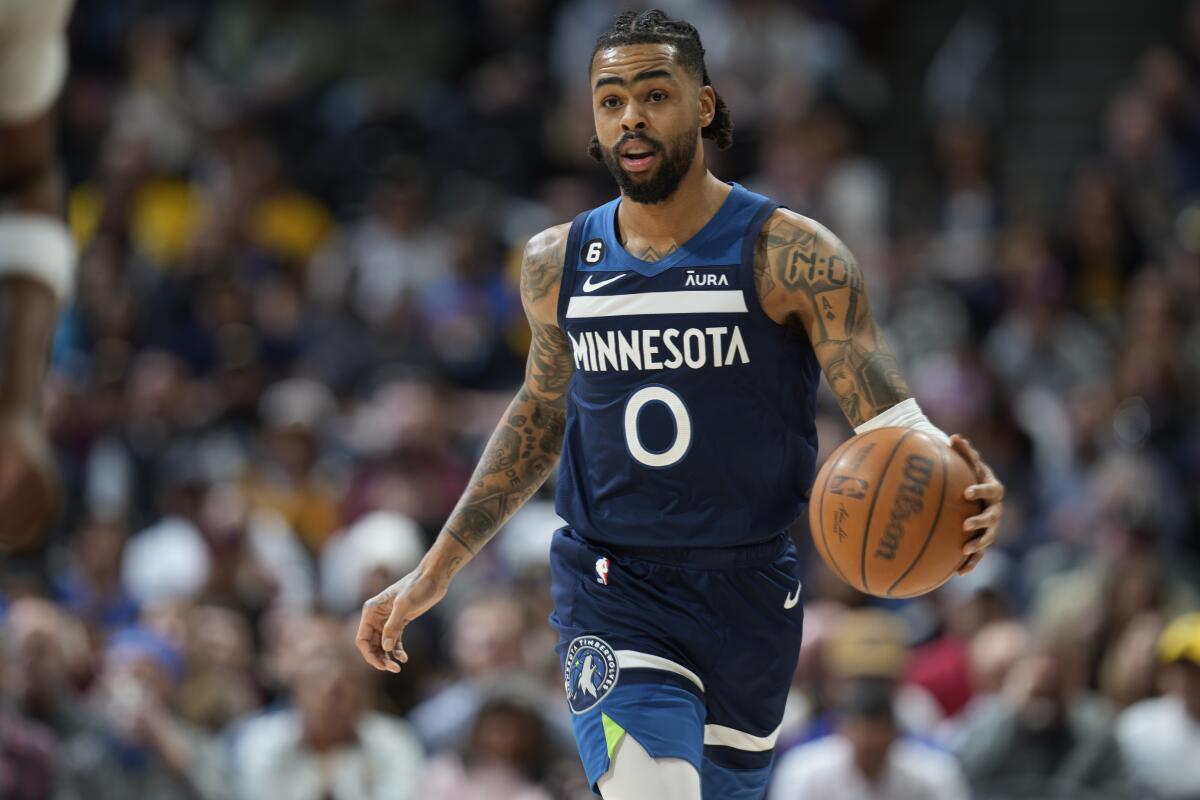 Minnesota Timberwolves guard D'Angelo Russell brings the ball up the court against the Denver Nuggets.