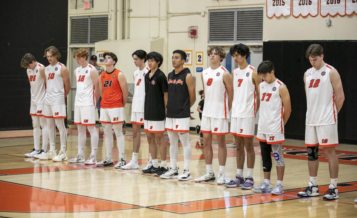The Huntington Beach boys' volleyball team observes a moment of silence in recognition of the loss of Rocky Ciarelli.