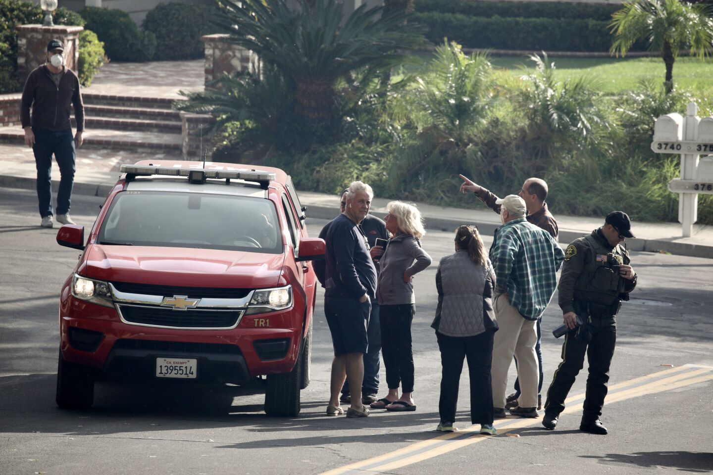 Yorba Linda residents gather around an Orange County Fire Authority vehicle.
