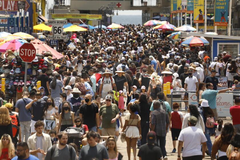 Santa Monica, CALIFORNIA—May 30, 2021--People flock to Santa Monica Pier and Santa Monica beach on Memorial Day, May 30, 2021. (Carolyn Cole / Los Angeles Times)