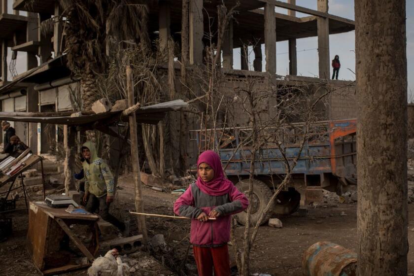 HAJIN , SYRIA - FEBRUARY 16: A young girl stands in front of a destroyed building on February 16, 2019 in Hajin, Syria. Civilians have begun returning to some small towns close to Bagouz that were recently liberated by the US-led coalition and the Syrian Democratic Forces (SDF). Fighting continues in a small section in the west of Bagouz. SDF General Ciya announced today that ISIl fighters were holding just a 700sq meter area. (Photo by Chris McGrath/Getty Images) ** OUTS - ELSENT, FPG, CM - OUTS * NM, PH, VA if sourced by CT, LA or MoD **