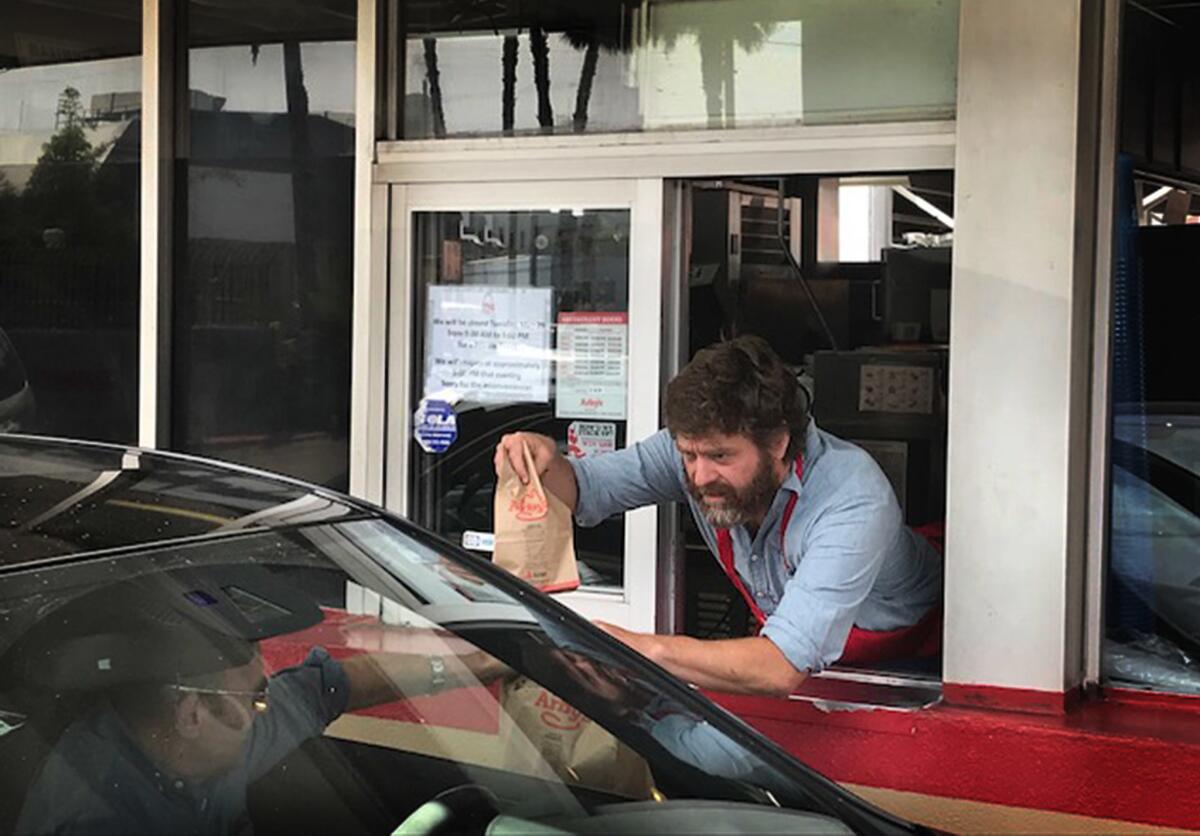 Zach Galifianakis serves customers during the FYC event for FX's "Baskets" at Arby's on May 29 in Los Angeles.