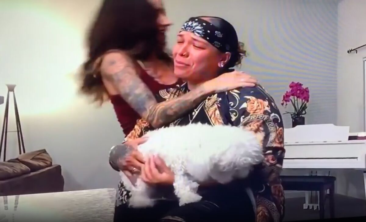 Celina Graves, holding her dog, Hope, and getting a hug from her wife, Erica, on "America's Got Talent" on July 28.