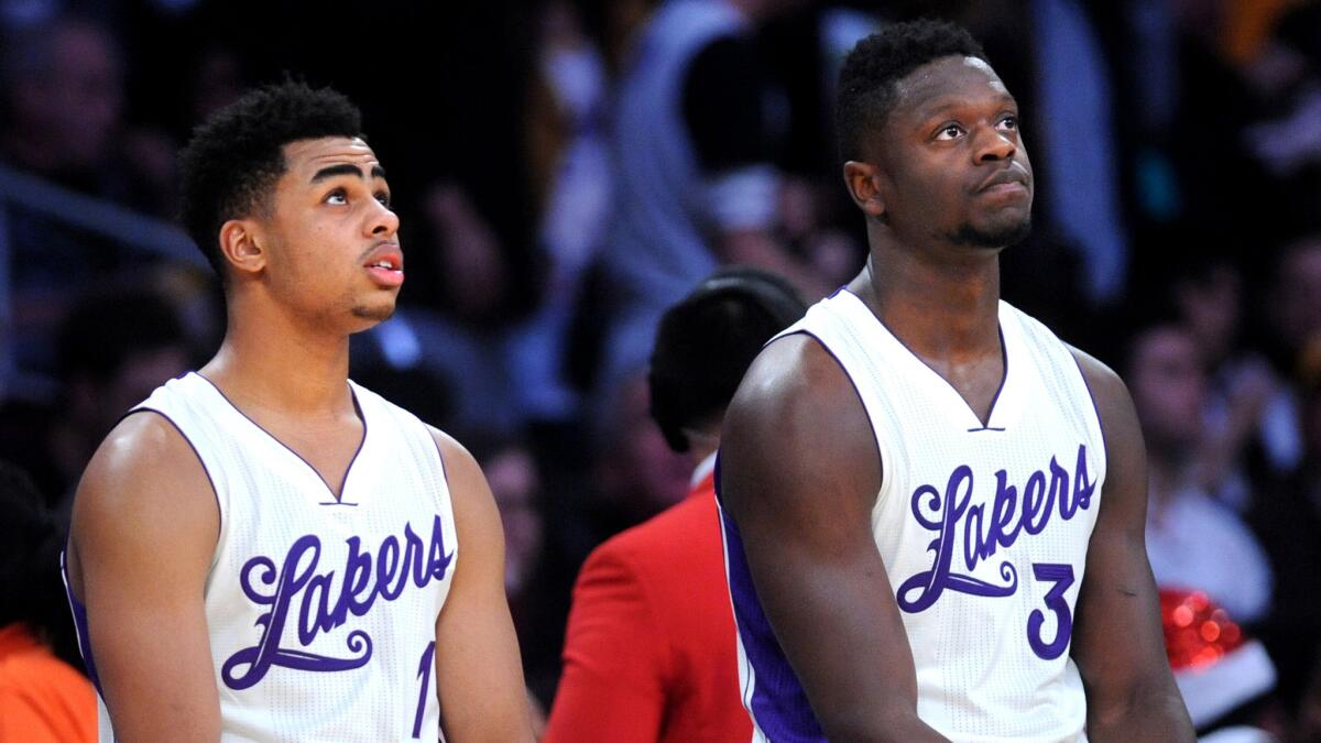 Lakers guard D'Angelo Russell, left, and forward Julius Randle, waiting to enter the game against the Clippers on Friday, have been reserves for the last 10 games.