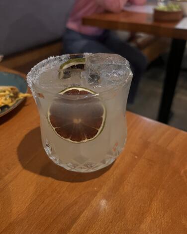 The margarita at Guerrilla Tacos with a salt rim and a dried blood orange slice as garnish.