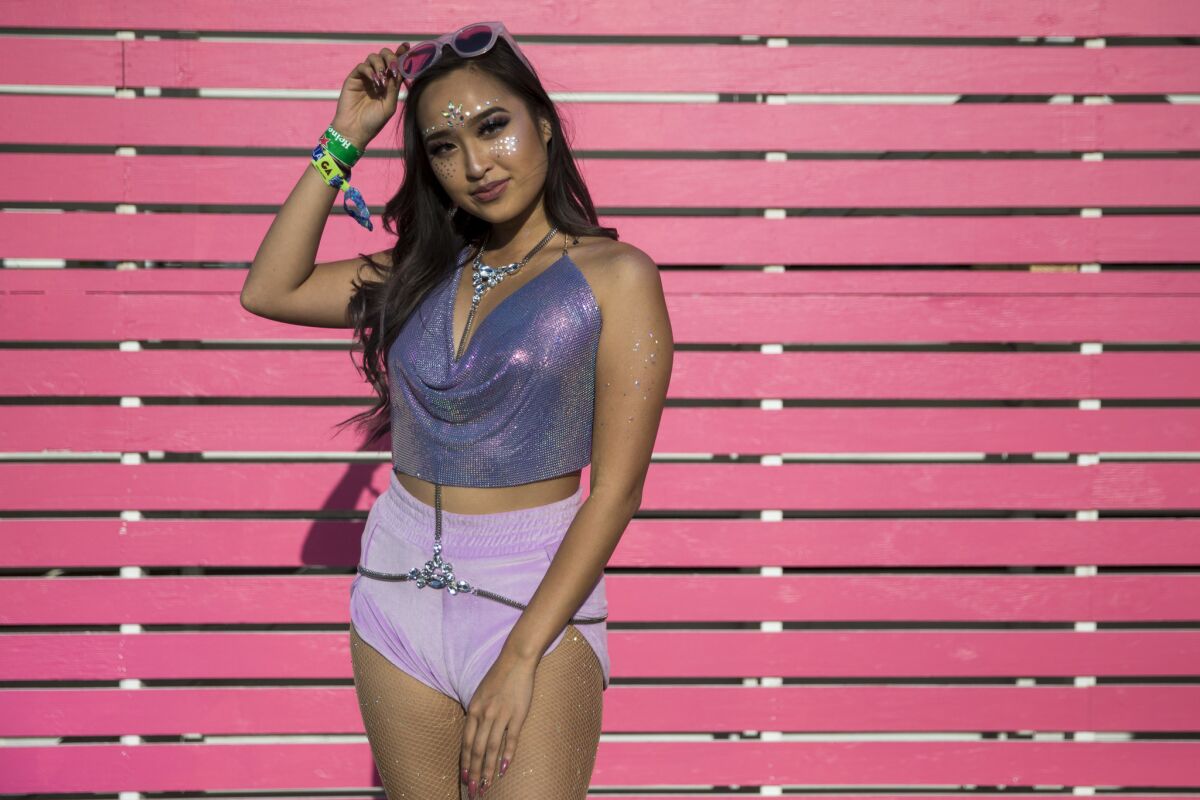 Natalie Nguyen, 22, of San Jose keeps cool in shades of purple during Day 1 of the 2018 Coachella Valley Music and Arts Festival.