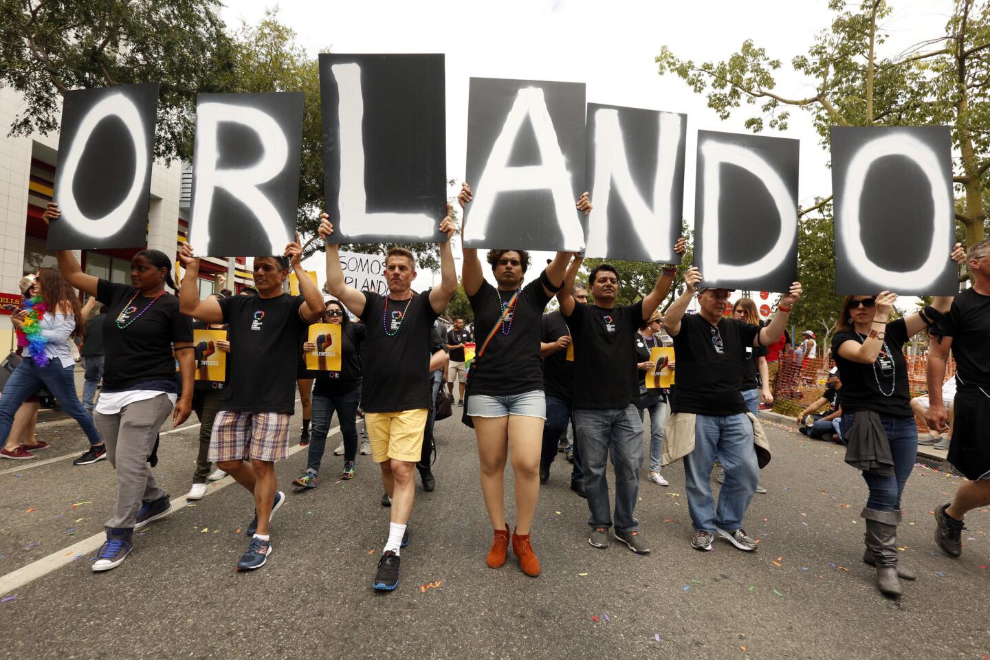 Marchers hold letters that spell out Orlando in support of the victims in the shooting during the annual Gay Pride parade in West Hollywood.