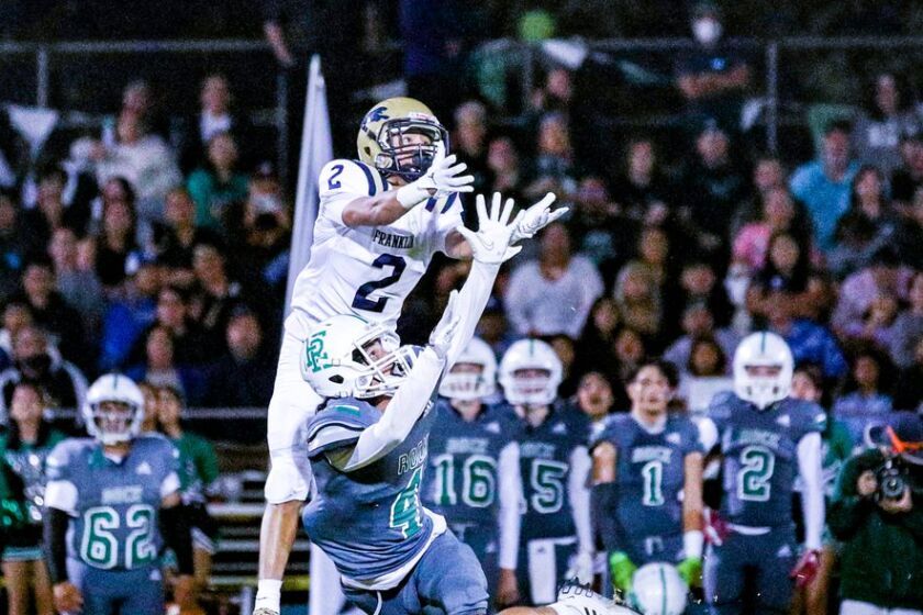 Hector Ceballos of Franklin leaps over Anthony Leon-Vidales of Eagle Rock to make 42-yard catch.