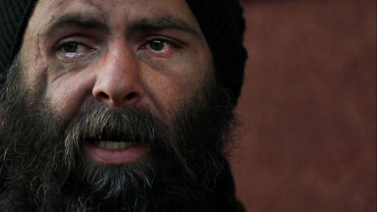 A homeless veteran begins to cry in Hollywood on Feb. 20.