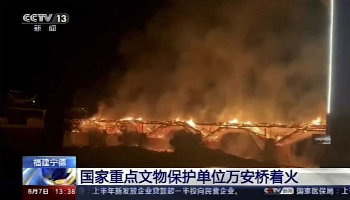 Video image of wooden bridge in flames