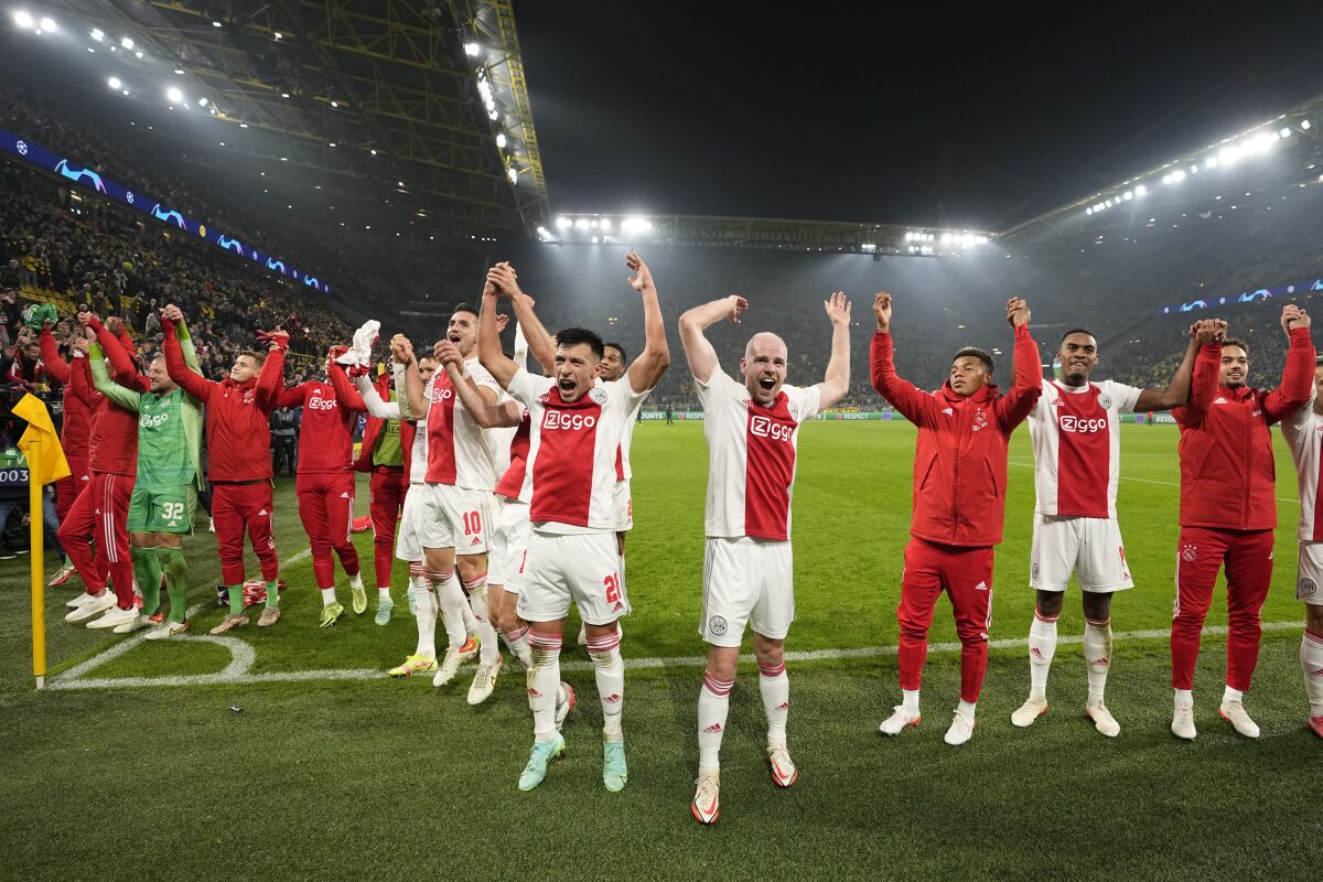 Ajax players celebrate at the end of the Champions League group C soccer match between Borussia Dortmund and Ajax Amsterdam in Dortmund, Germany, Wednesday, Nov. 3, 2021. Ajax won 3:1. (AP Photo/Martin Meissner)
