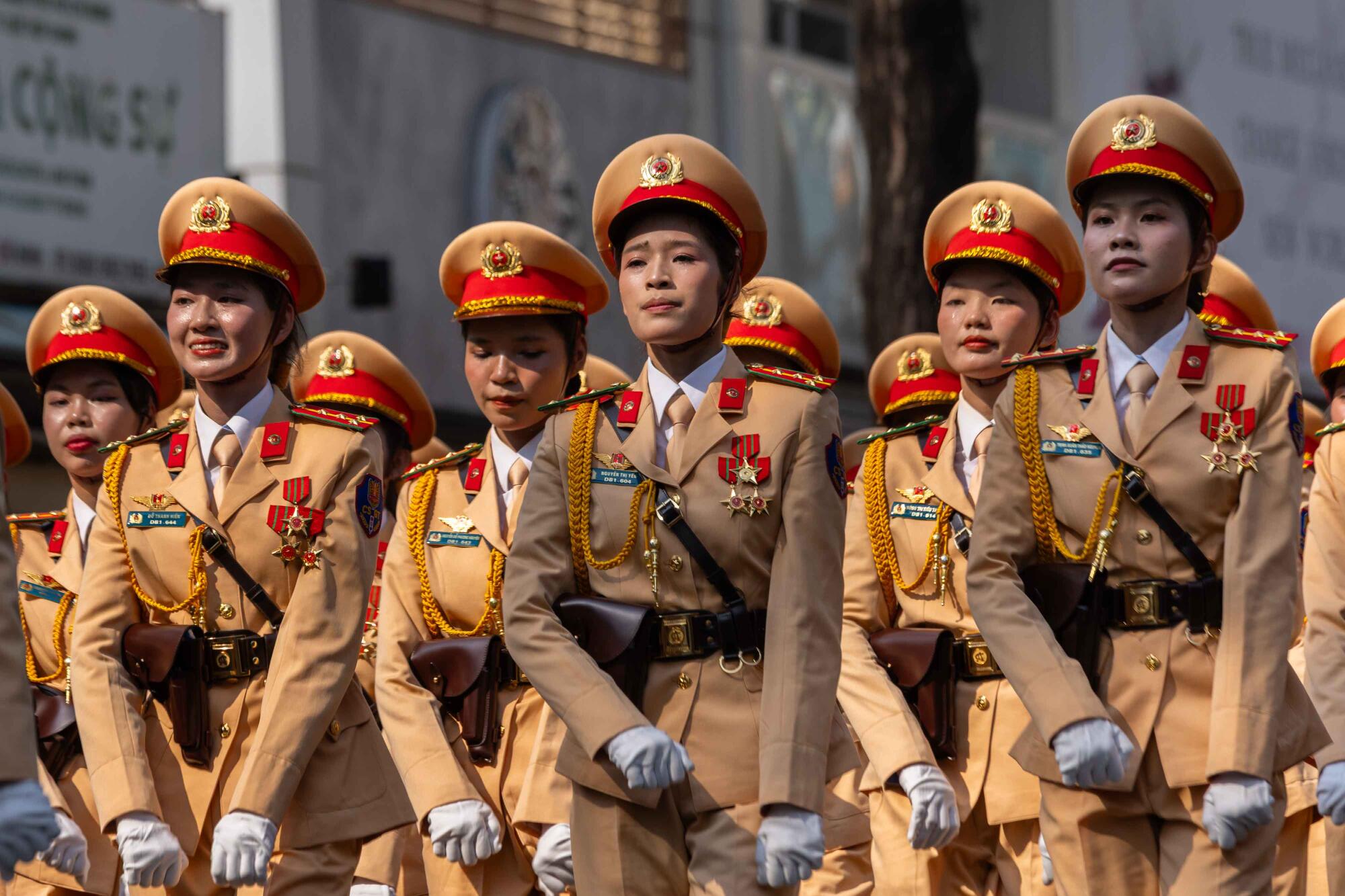 A women's unit of Vietnamese Traffic Police march during a military parde