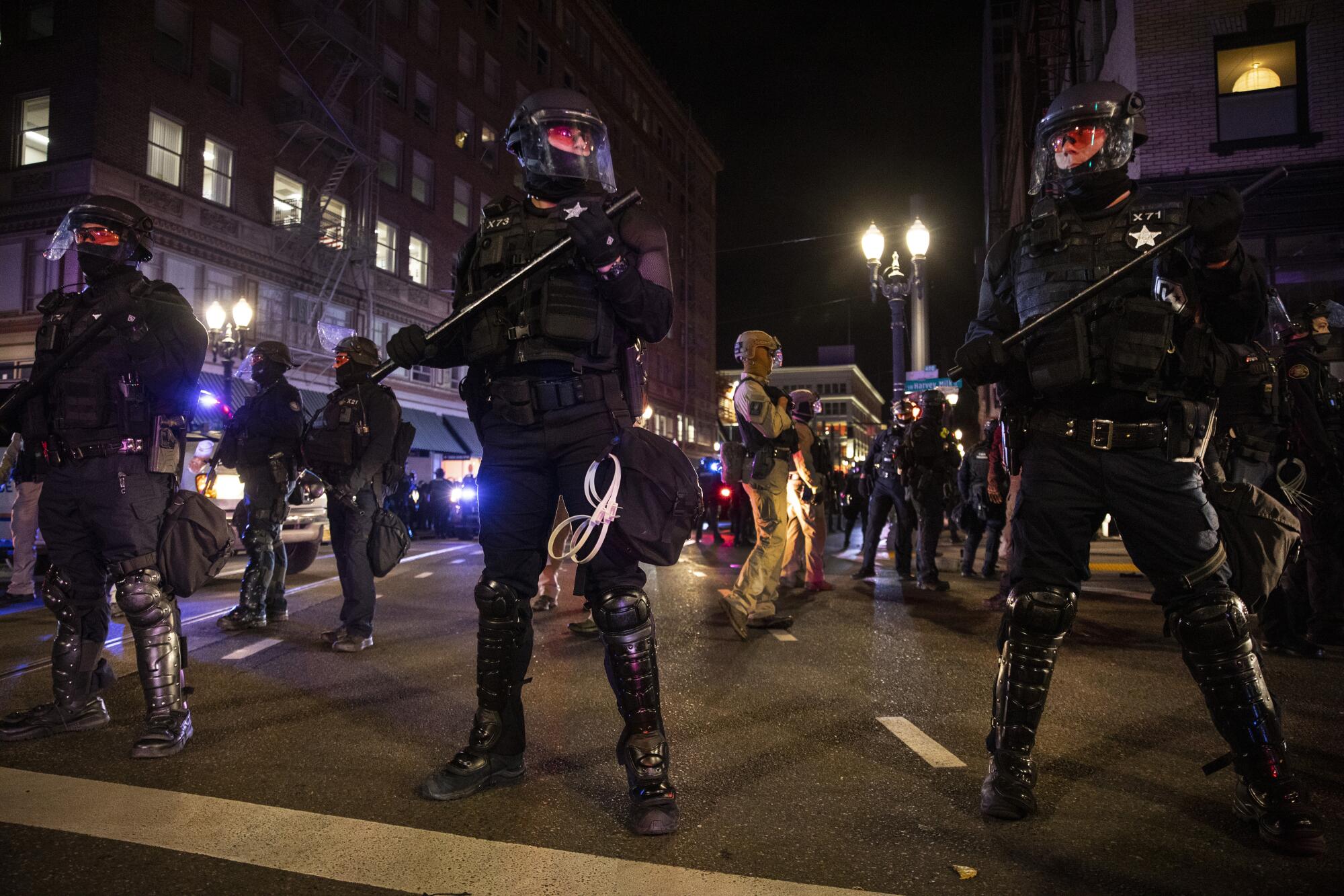 Police form a a perimeter during Portland, Ore., protests following the Nov. 3 presidential election.