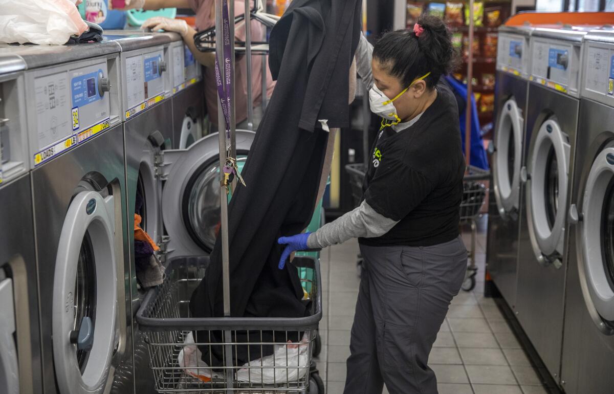 Irma Juárez washes clothes and bedding at a coin laundry in her Pico-Union neighborhood.