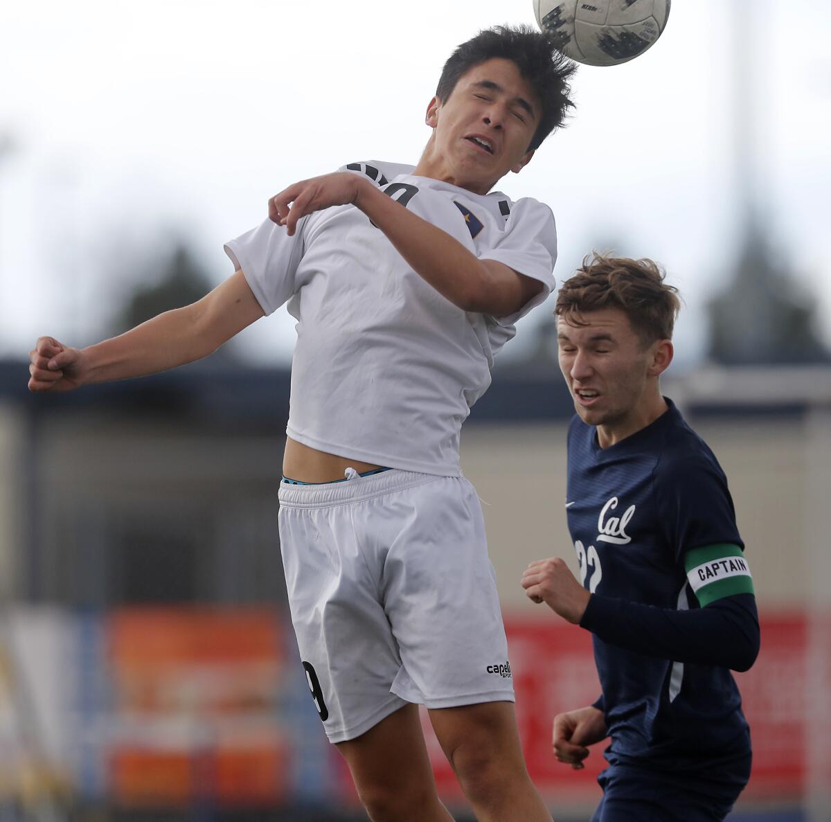 Marina's Damiond Mendoza, left, heads the ball against Whittier California's Kevin Closson on Dec. 26, 2019.
