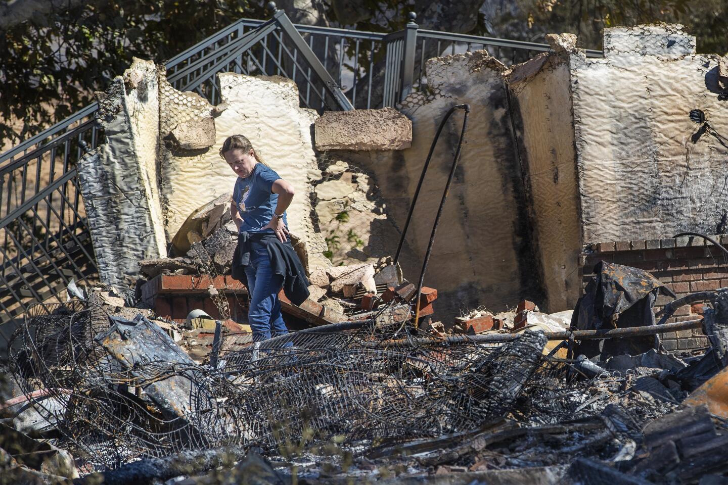 A family member views the destruction of a home that was destroyed in the Hillside fire in San Bernardino.