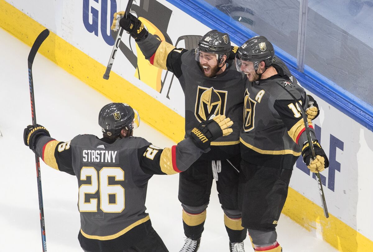 Vegas Golden Knights' Reilly Smith (19) celebrates his goal against the Dallas Stars with Paul Stastny (26) and Jonathan Marchessault (81) during third-period NHL Western Conference final playoff game action in Edmonton, Alberta, Monday, Sept. 14, 2020. (Jason Franson/The Canadian Press via AP)
