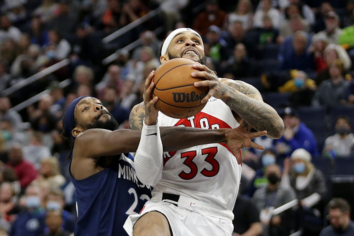 Toronto Raptors guard Gary Trent Jr. (33) is fouled by Minnesota Timberwolves guard Patrick Beverley (22) during the second half of an NBA basketball game Wednesday, Feb. 16, 2022, in Minneapolis. (AP Photo/Andy Clayton-King)