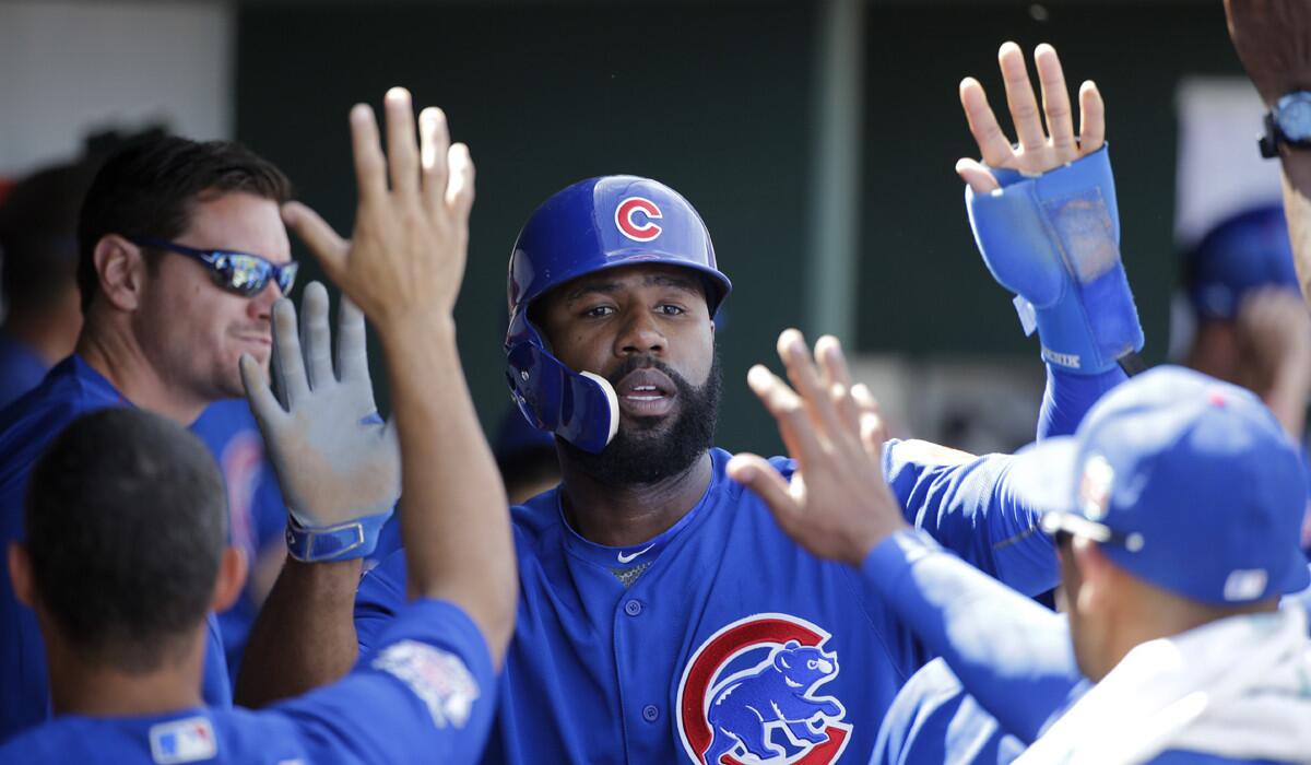 Chicago Cubs' Jason Heyward celebrates after scoring against the Cincinnati Reds during a spring training baseball game on Tuesday in Goodyear, Ariz.