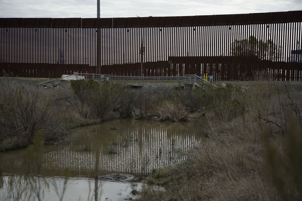 Rainwater flows from San Diego toward the U.S.-Mexico border fence at Otay Mesa in February. 
