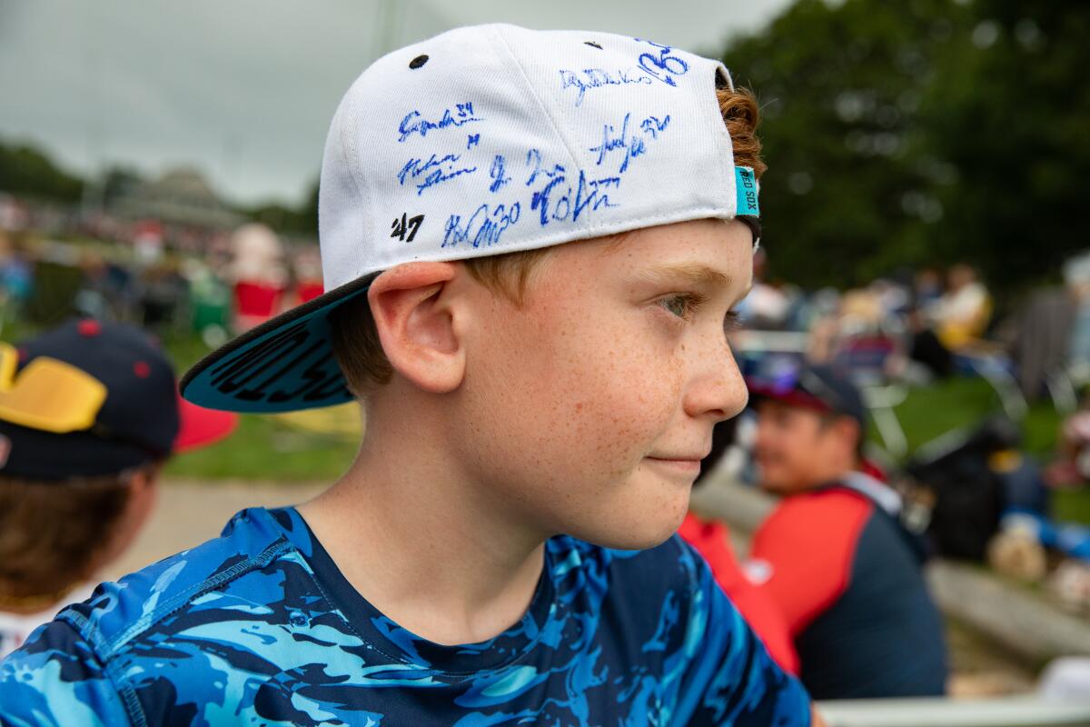 A young fan shows off his autographed hat during a Y-D Red Sox game.