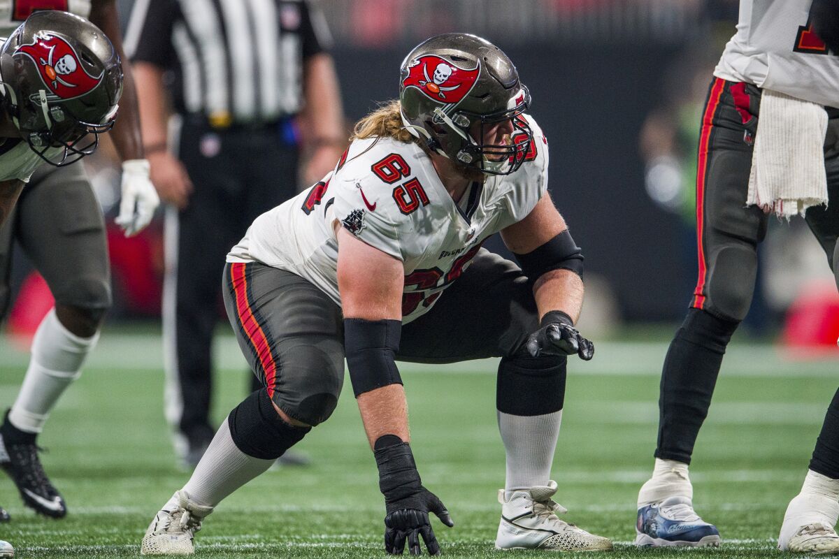 FILE - Tampa Bay Buccaneers guard Alex Cappa (65) lines up during the second half of an NFL football game against the Atlanta Falcons, Sunday, Dec. 5, 2021, in Atlanta. Cappa has agreed to a free agent contract with the Cincinnati Bengals. (AP Photo/Danny Karnik, File)