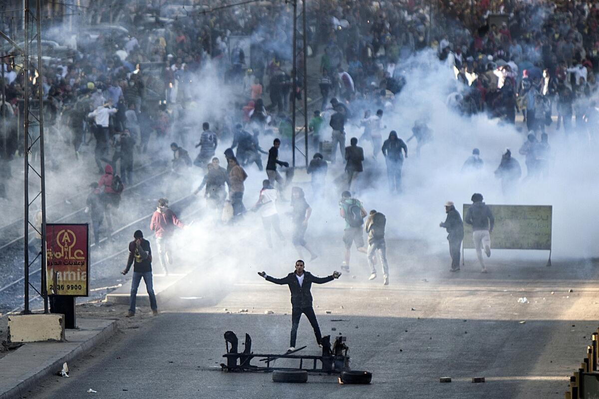 Muslim Brotherhood and supporters of ousted president Mohammed Morsi clash with Egyptian riot police during a demonstration near the presidential Palace in Cairo.